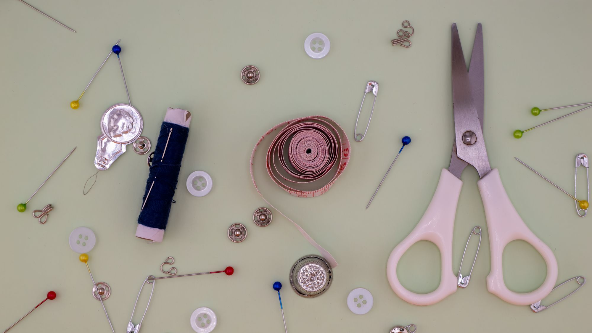 Scissors, thread, tape measure and preparation tools — reference photograph